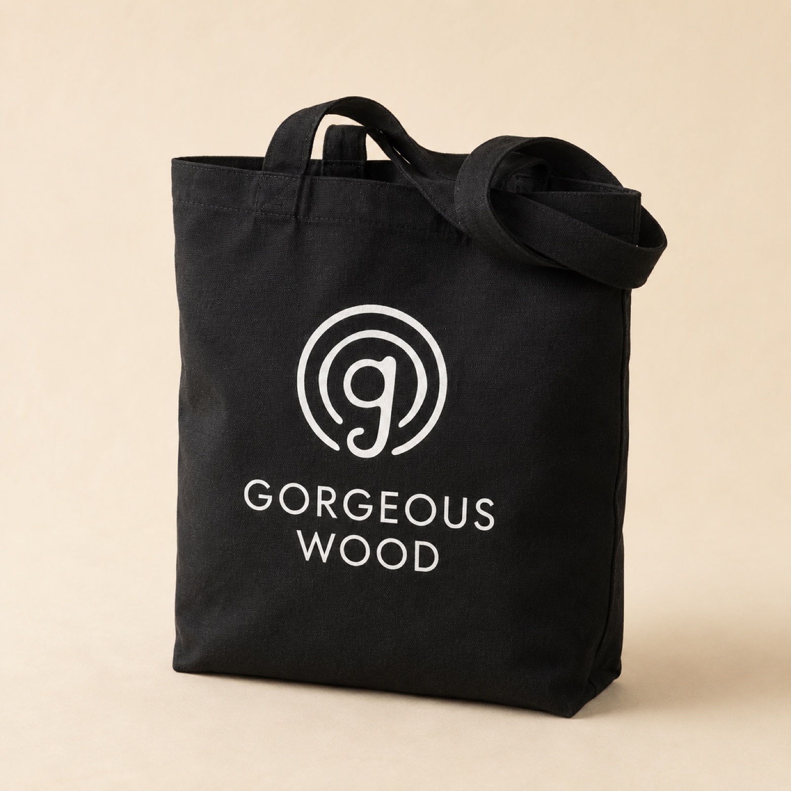 Black canvas tote with white Gorgeous Wood mark and wordmark